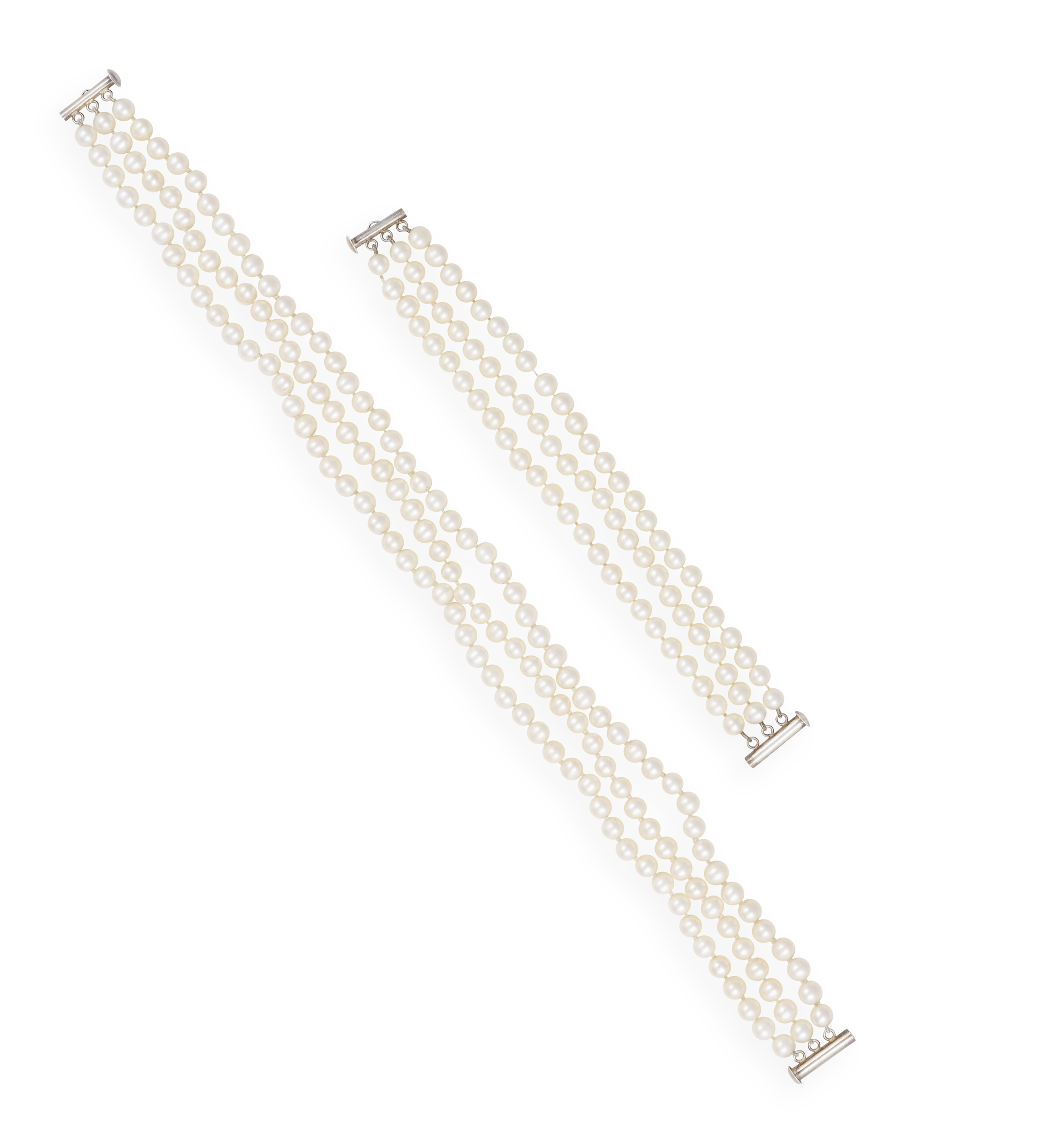 A THREE-ROW CULTURED PEARL NECKLACE, of white tint, mounted on silver, length 52cm (can also be worn