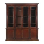 A VICTORIAN MAHOGANY FOUR DOOR BOOKCASE, with glazed doors above closed cupboard doors, decorated