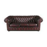 A CHESTERFIELD BUTTON BACK THREE-SEATER SOFA, of typical form, covered in wine hide, with three