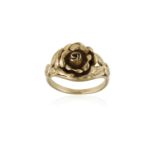 A GOLD FLOWER RING, centrally set with a gold flowerhead with polished and engraved petals between