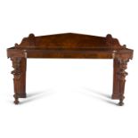 A WILLIAM IV MAHOGANY BREAKFRONT SERVING TABLE, with raised panel back, the front legs carved with