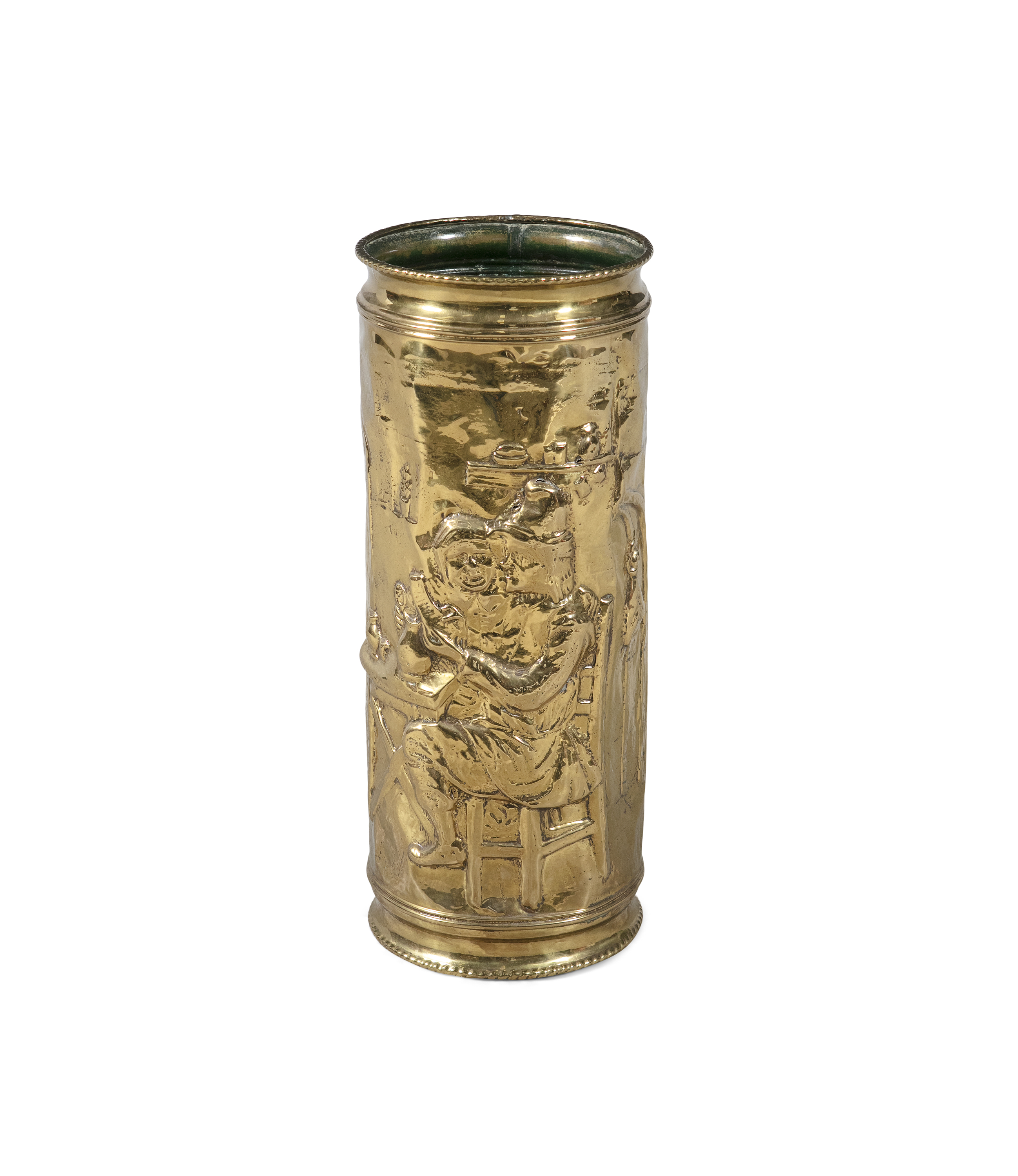A BRASS CYLINDRICAL STICK STAND, with embossed figural decoration, in the manner of David Teniers.
