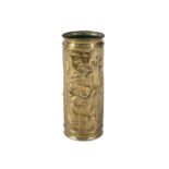 A BRASS CYLINDRICAL STICK STAND, with embossed figural decoration, in the manner of David Teniers.