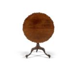 A GEORGE III MAHOGANY TILT TOP WINE TABLE, with piecrust rim , raised on turned centre pillar, on