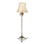 AN EDWARDIAN BRASS STANDARD OIL LAMP, converted to electricity, raised on tripod supports. 140cm