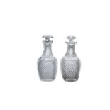 A PAIR OF IRISH CUT GLASS DECANTERS AND STOPPERS, c.1800 of baluster form, each with fitted mushroom
