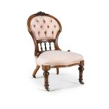 A VICTORIAN MAHOGANY FRAMED UPHOLSTERED LOW CHAIR, with button back fabric in salmon pink, on