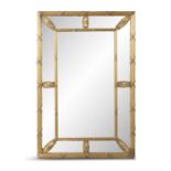 AN EDWARDIAN GILTWOOD AND GESSO COMPARTMENTAL MIRROR, the central rectangular bevelled plate