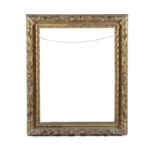 A GILTWOOD AND GESSO PICTURE FRAME, carved with trailing foliage and berries, each side centred with