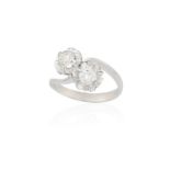 A DIAMOND CROSSOVER RING, obliquely-set with an old brilliant and a brilliant-cut diamond within a