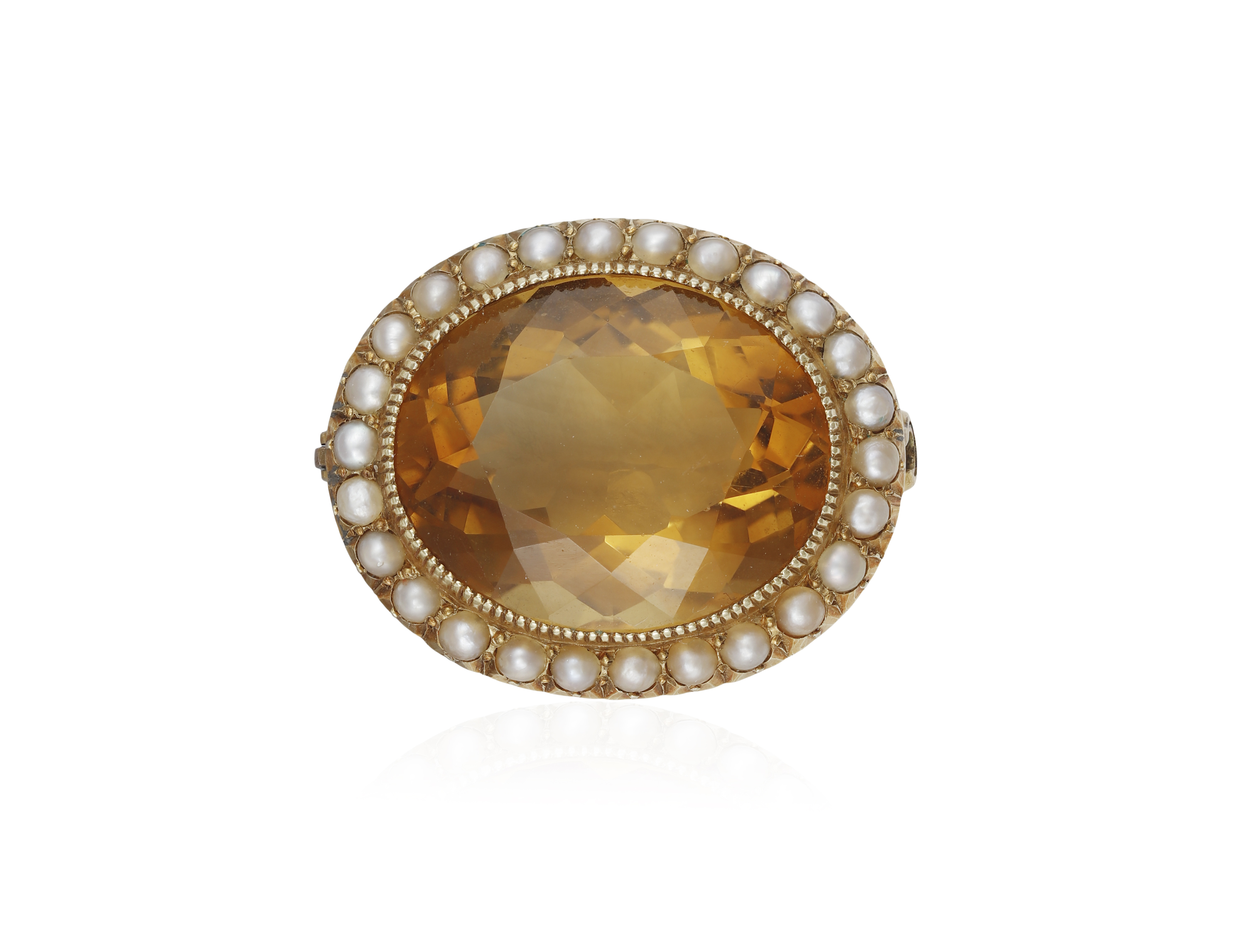 A VICTORIAN CITRINE AND SEED PEARL BROOCH The oval-shaped citrine within collet-setting to a