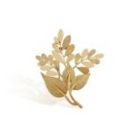 A GOLD BROOCH, BY HERMÈS, CIRCA 1965 Of floral design with polished and textured gold leaves, in 18K