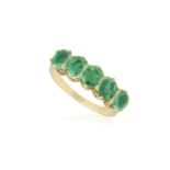 AN EMERALD FIVE-STONE RING Set with a graduated row of oval-shaped emeralds with claw-setting, to