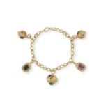 A GEM-SET CHARM BRACELET, CIRCA 1965 The fancy-link gold chain suspending five stylised lanterns