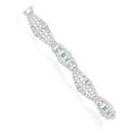 AN ART DECO DIAMOND AND EMERALD BRACELET, CIRCA 1925 Of articulated design, composed of openwork