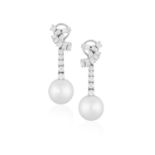 A PAIR OF CULTURED PEARL AND DIAMOND PENDENT EARRINGS, CIRCA 1955 Each stylised ribbon scroll