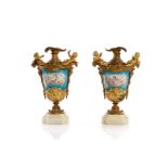 PAIR OF MINIATURE ORMOLU MOUNTED PORCELAIN URNS