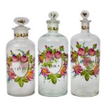 Tres frascos de farmacia en cristal con decoración esmaltada de flores, S. XIX