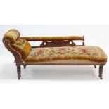 A late Victorian oak-frame chaise longue (requires reupholstering) on short turned legs with ceramic