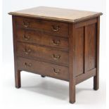 A small oak chest, fitted four long graduated drawers with brass swing handles & on short square