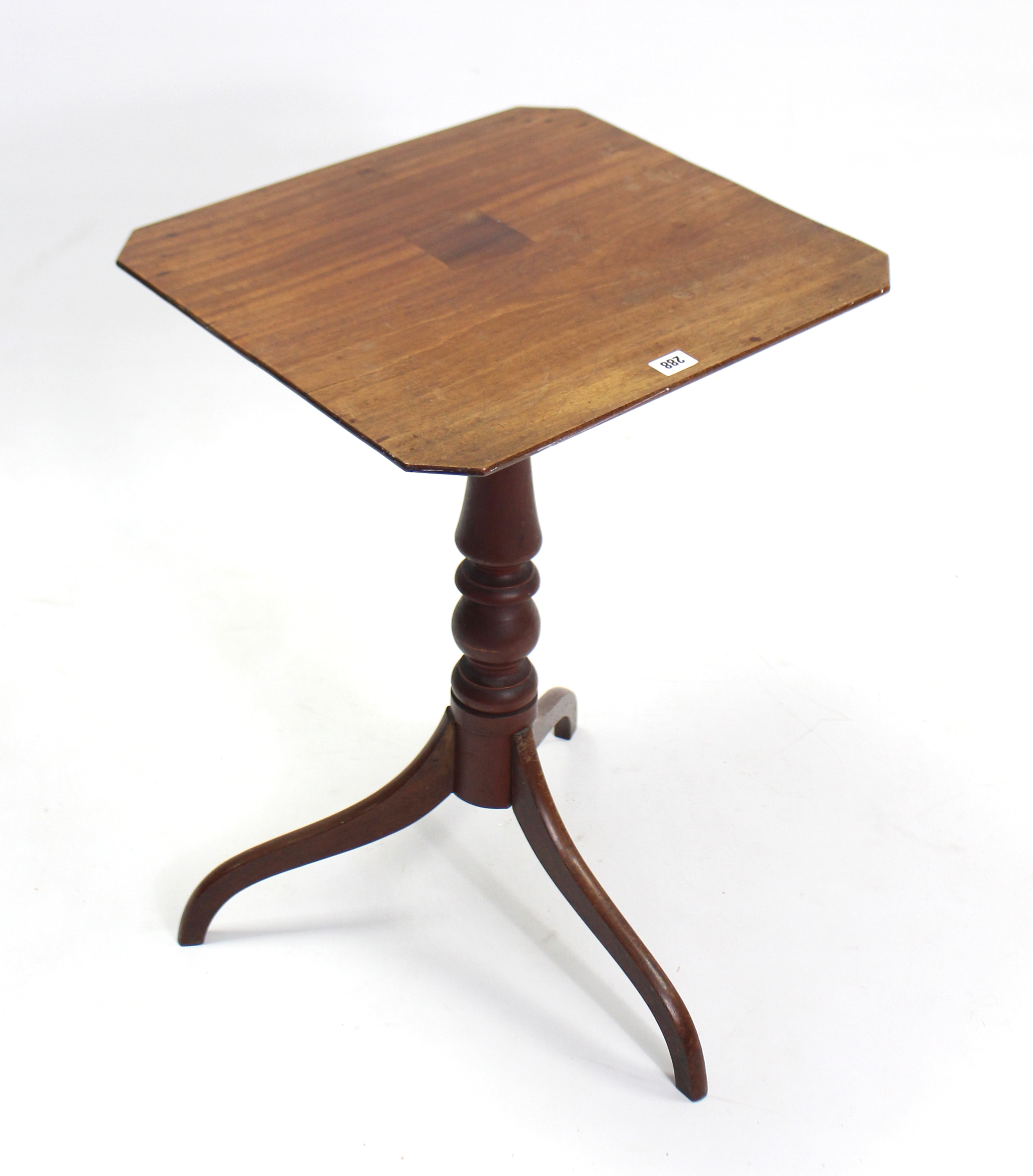 A 19th century mahogany tripod table with canted corners to the rectangular top, & on vase-turned