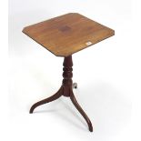 A 19th century mahogany tripod table with canted corners to the rectangular top, & on vase-turned