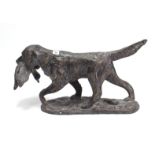 A large bronzed spelter ornament in the form of a hunting dog with bird in its mouth, 26½” long x
