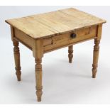 A pine side table, fitted centre frieze drawer & on turned tapered legs, 35” wide.