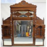 A late 19th/early 20th century large carved oak overmantel mirror inset nine bevelled plates, 60”