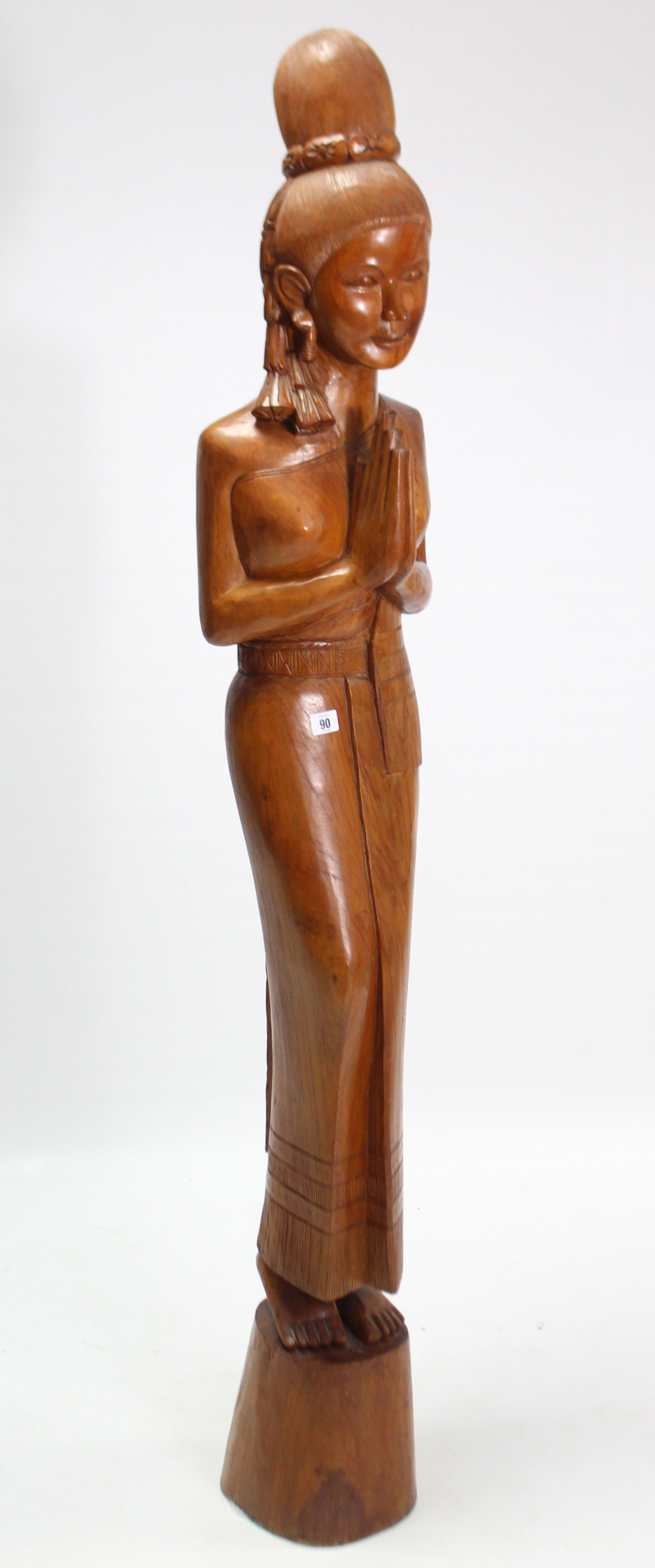 A large carved hardwood Thai female figure, 65¼” high.