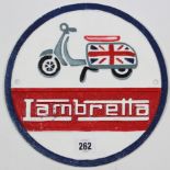 A reproduction painted cast-iron circular plaque “Lambretta”, 9¼” diam.
