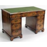 A Victorian burr-walnut pedestal desk inset green baize to the rectangular top, fitted with an