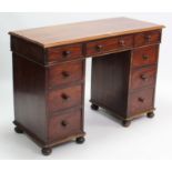 A Victorian mahogany pedestal desk fitted with an arrangement of nine drawers, & each pedestal on