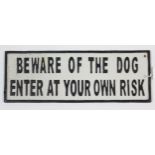 A modern painted cast-iron rectangular sign “BEWARE OF THE DOG ENTER AT YOUR OWN RISK”, 5” x 13¾”.