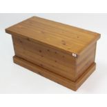 A pine blanket box with hinged lift-lid, & on plinth base, 32¾” wide x 16¼” high.