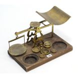 A Mordan & Co. of London large brass postal scale to weigh a maximum of 75 lbs, mounted on wooden