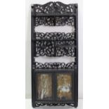 A Chinese black lacquered wall cabinet enclosed by pair of panel doors with three open shelves