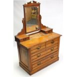 A late Victorian walnut dressing chest with rectangular swing mirror to the stage back, fitted two