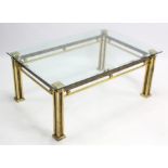 A brass rectangular low coffee table on four short square legs; & with bevelled tempered-glass