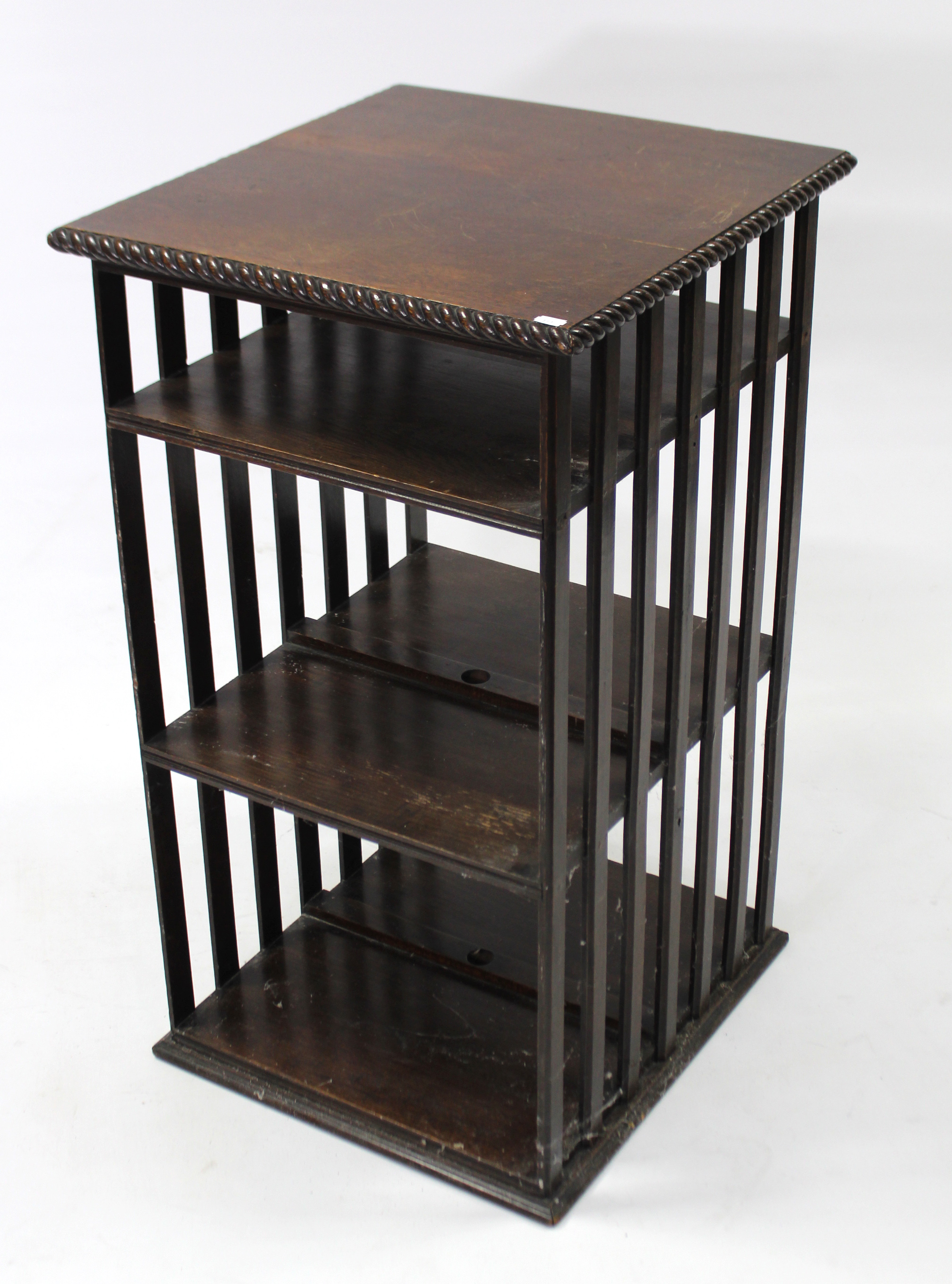 An oak small standing bookcase, fitted two shelves enclosed by pair of