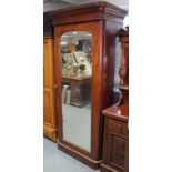 A Victorian mahogany narrow wardrobe with moulded cornice, enclosed by rectangular mirror door, & on