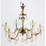 A brass six-branch chandelier hung with cut-glass prism drops, 20” wide x 10” high.