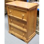 A pine small upright chest, fitted four long drawers with turned knob handles, & on shaped plinth