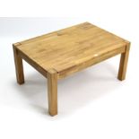 A light oak rectangular low coffee table fitted frieze drawer to one side; & on short square legs;