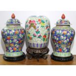 A pair of Chinese baluster-shaped vases with bright-coloured floral decoration, 16” high, a pair