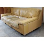 A Tetrad tan leather three-seater settee with square back, & on short square legs, 76” long.