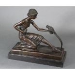 After D. H. Chiparus; a cast bronze figure of a girl in 1930s dress, on one knee feeding a parrot,