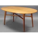 A mid-20th century cherrywood oval dining table on square tapered legs with diagonal stretchers; 66”