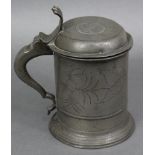A late 17th/early 18th century pewter tankard, the domed hinged lid with roundel depicting Roman