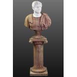 A MARBLE BUST OF A ROMAN EMPEROR, with white head & neck, rouge shoulders, robe, & socle, on rouge